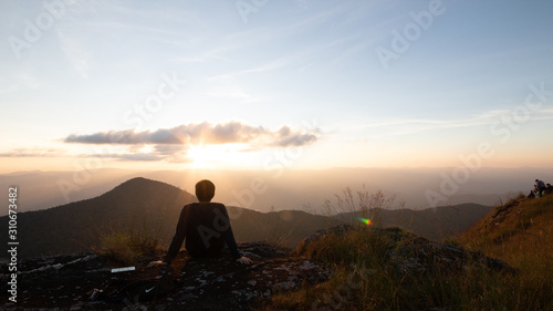 Tourists watch the atmosphere on a high peak.