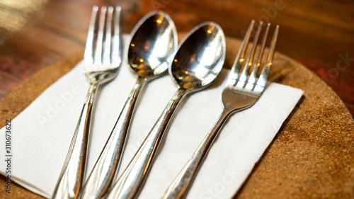 Spoons and forks are lined up.
