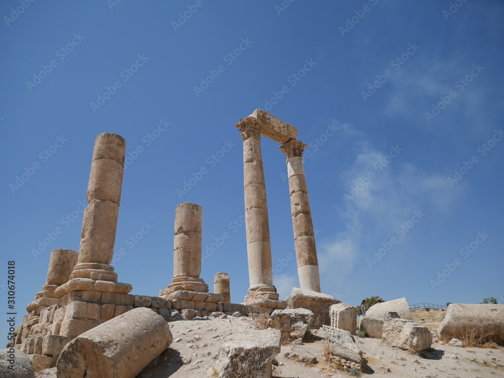 Tall majestic pillars of the ruins of the Roman site of Amman Citadel on a hill in the city center of the capitol of Jordan
