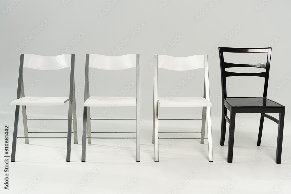 Obraz premium Modern white and black chairs on grey background
