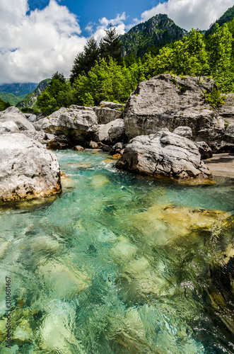 Crystal clear river Lumi i Thethit in National Park Theth in Albania