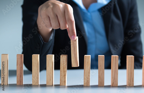 man hand pick one from many wooden blocks.business concept of choosing the right amongst .other ones,Planning,risk and strategy,businessman gambling investment,