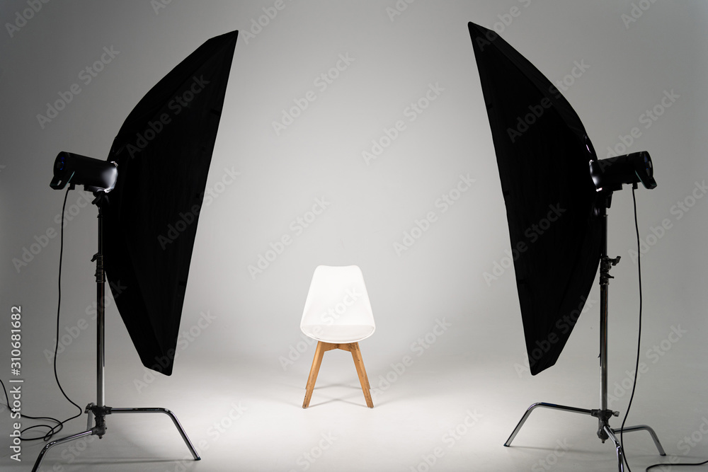 White modern chair with studio light on grey background White modern chair with studio light on grey background