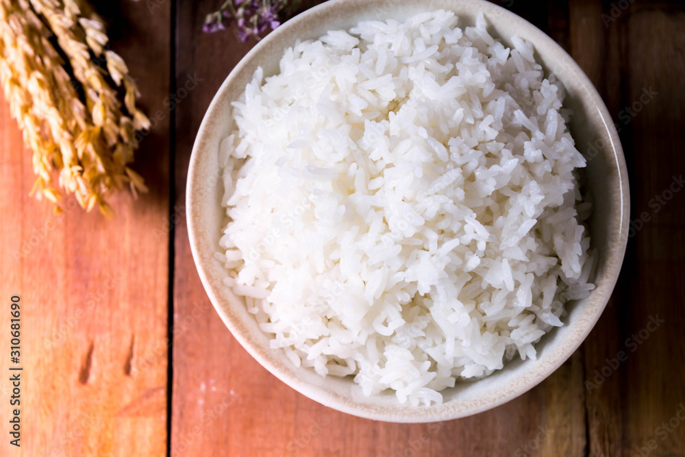 Soft focus, the picture on the top of the cup of white rice is delicious Laid on the old wooden floor Soft focus, the picture on the top of the cup of white rice is delicious Laid on the old wooden floor