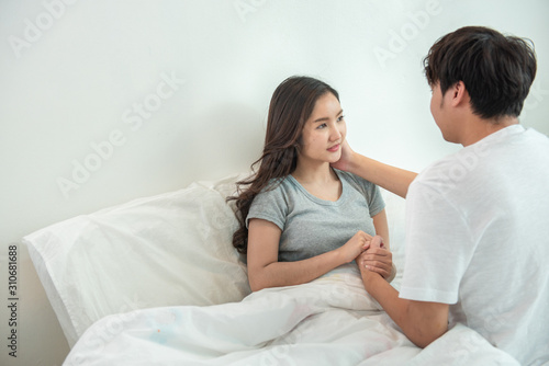 Happy young asian couple encourage and hugging on bed together,Happy and smiling expected mom hope for pregnancy test,Positive thinking,Adult social care and valentine day concept.