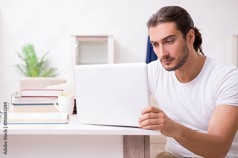 Young male student preparing for exams at home Young male student preparing for exams at home