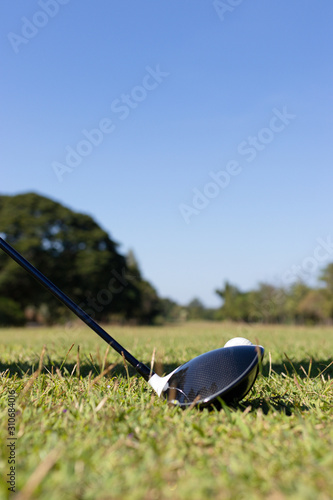 Close Up of Golf club and ball in grass.