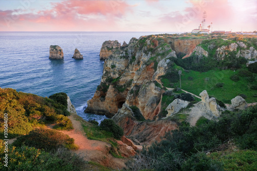 seascape. cliffs and lighthouse on the shores of the atlantic ocean at sunset in the vicinity of the city of Lagos in Portugal