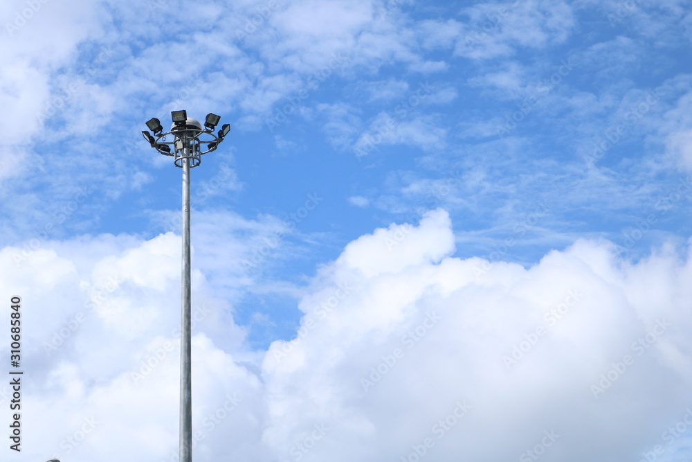 High light poles set high amidst clear skies at noon