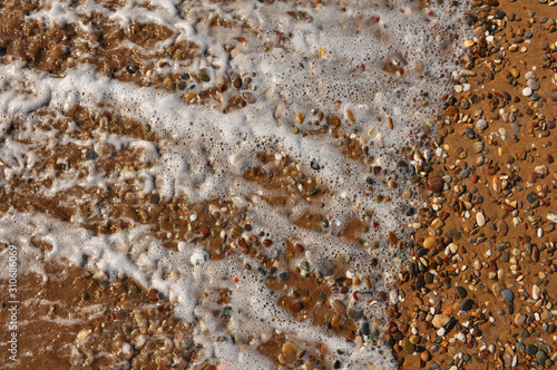 Sand, rocks and foam on the resort beach close-up © Victor Lazarev