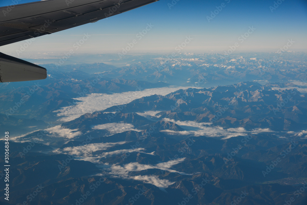 Aerial view above the clouds at mountain peaks Aerial view above the clouds at mountain peaks