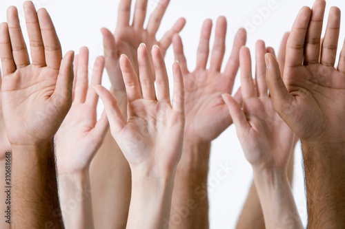 Closeup Of Raised Multiethnic Hands