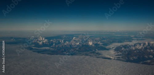 Aerial view above the clouds at mountain peaks