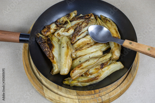 braised endives in a frying pan photo