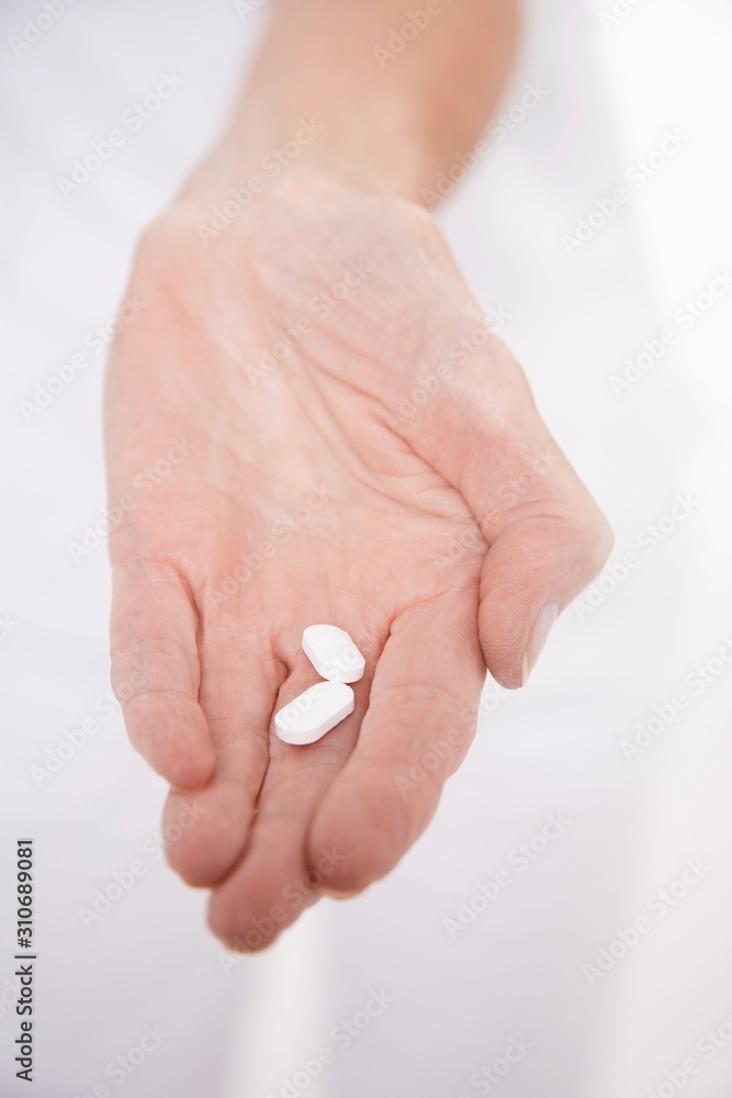 Hand Holding Out Two Pills Hand Holding Out Two Pills