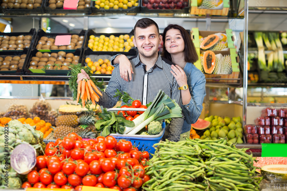 Adult couple examining various vegetables