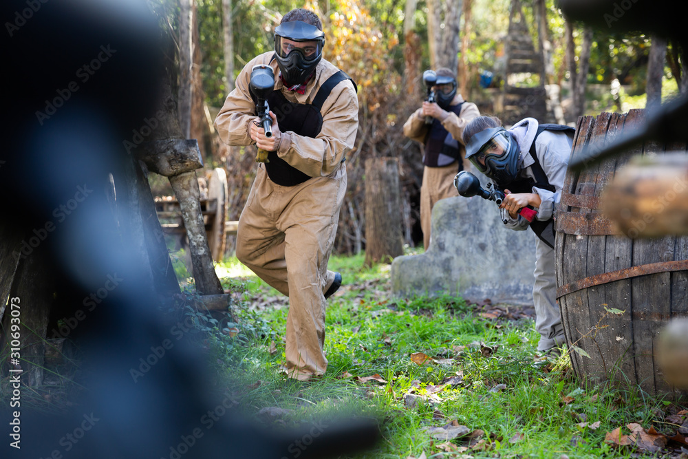 Fototapeta premium People playing paintball outdoors