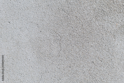 Gray textured cement wall background with fine concrete chips. Construction backgrounds