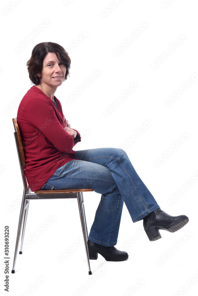 portrait of a woman sitting on a chair in white background,lookig at camera legs and arms crossed