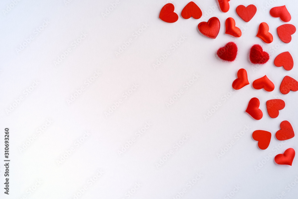 Festive composition from red hearts scattered on white background, valentines day concept, copy space