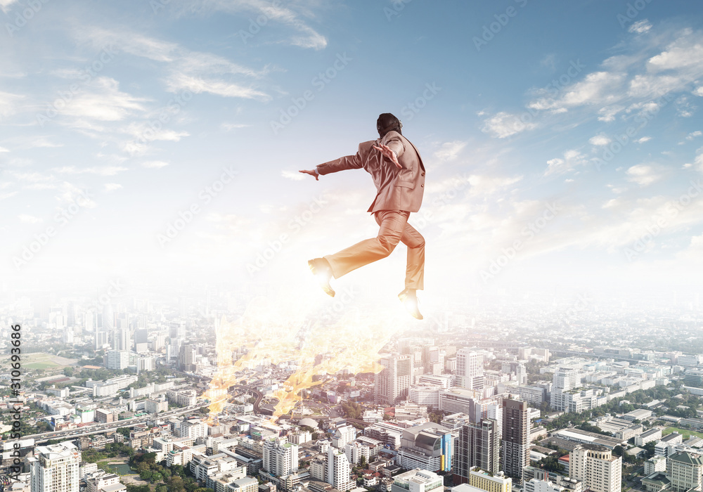 Businessman in suit and aviator hat flying in sky Businessman in suit and aviator hat flying in sky