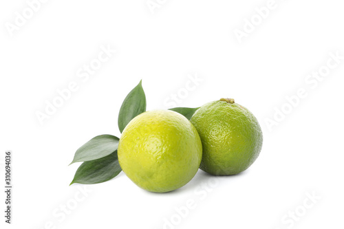 Fototapeta Naklejka Na Ścianę i Meble -  Limes with leaves isolated on white background. Juicy fruits