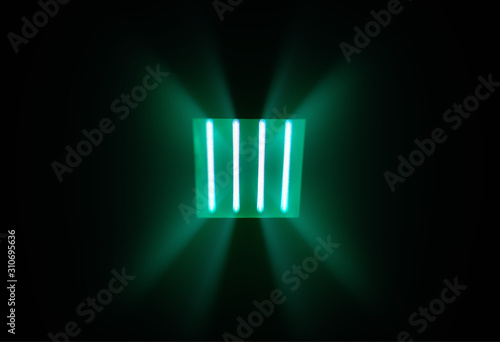 Dramatic green rays from neon lamps background