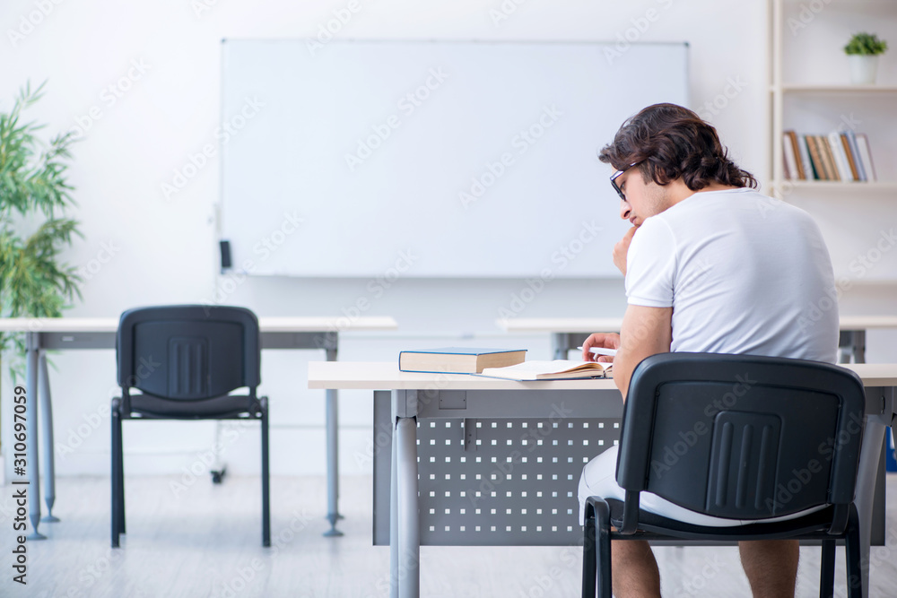 Young male student in front of whiteboard Young male student in front of whiteboard