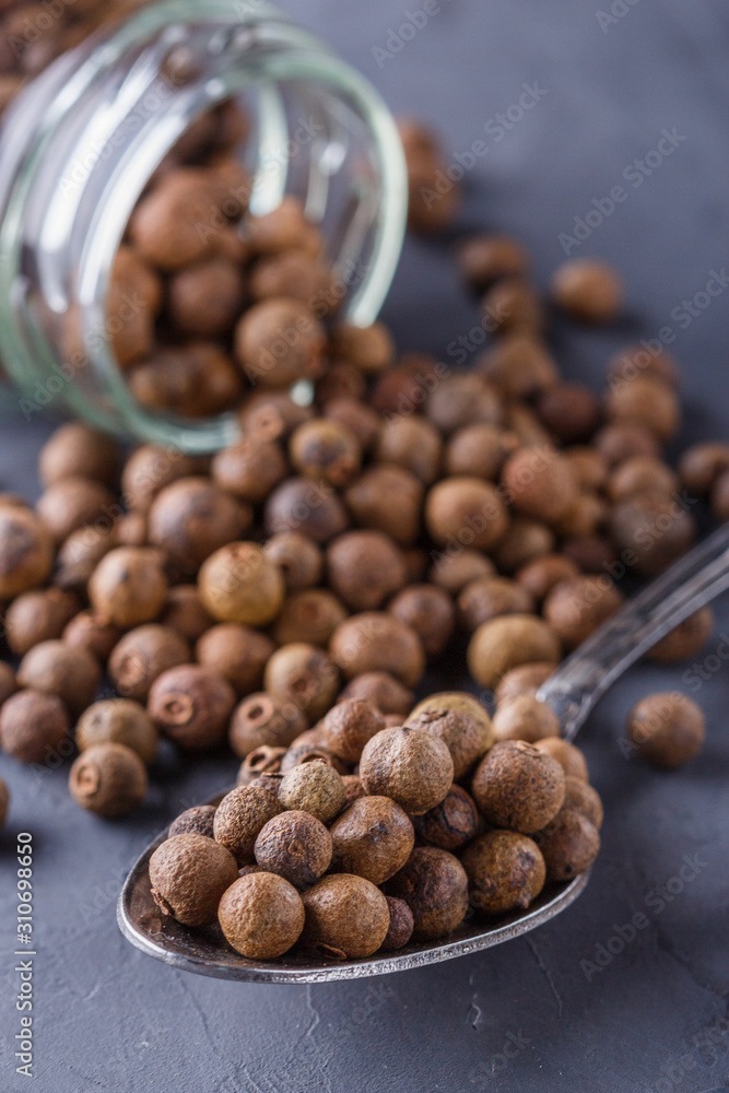 fresh spicy peppers allspice on a dark stone background fresh spicy peppers allspice on a dark stone background