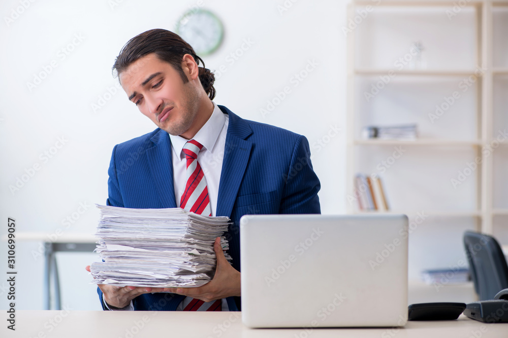 Young male businessman sitting in the office Young male businessman sitting in the office