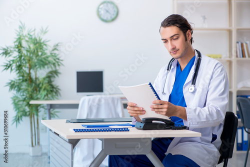 Young male doctor working in the clinic © Elnur