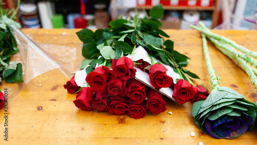 Red roses are on the counter in the flower shop. photo