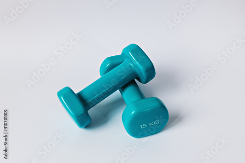 Blue dumbbells for fitness on a white background. Healthy lifestyle.