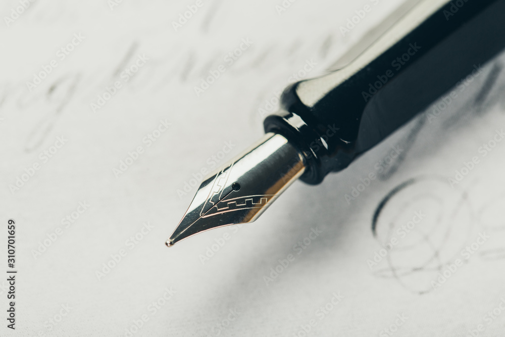 Fototapeta premium Fountain pen on an ancient handwritten letter. Old story. Retro style.