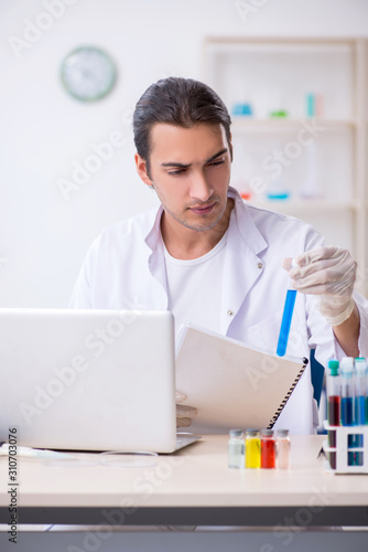 Young male chemist working in the lab