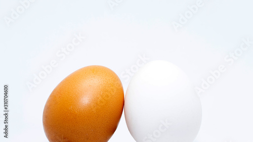 Wallpaper Mural Two isolated eggs of yellow and white color. close up on a white background. Torontodigital.ca