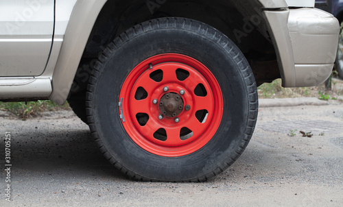 Closeup photo of red car wheel © evannovostro