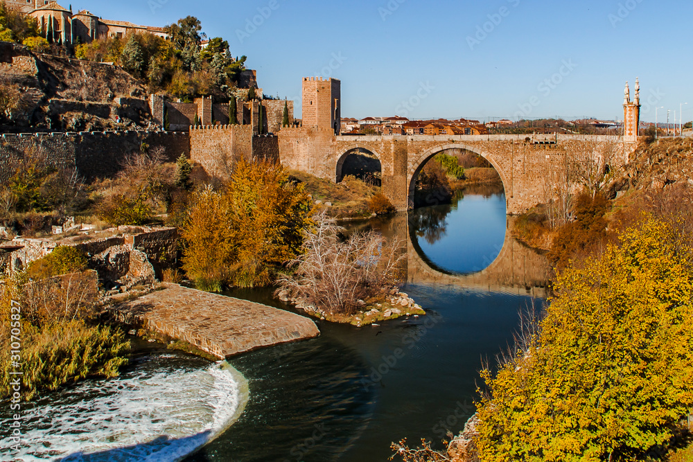 Roman bridge and tower over the Tagus river, Toledo, Spain.