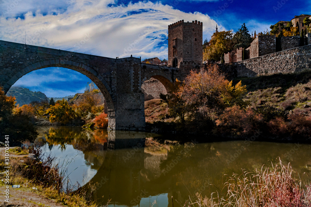 Roman bridge and tower over the Tagus river, Toledo, Spain.