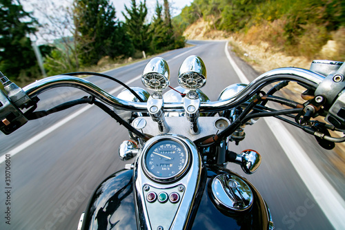 Man riding motorcycle and travelling on an empty country road. 