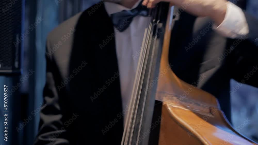 Music playing the cello. Close-up of hands and tools. Music playing the cello. Close-up of hands and tools.