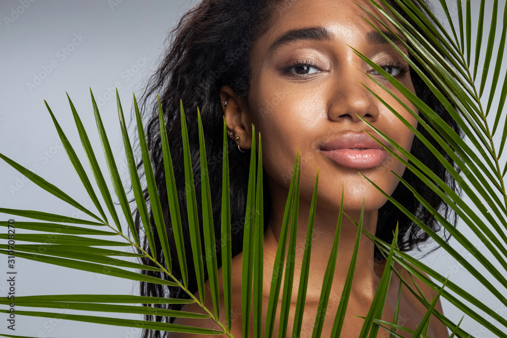 Fototapeta premium Calm woman with curly hair posing for camera
