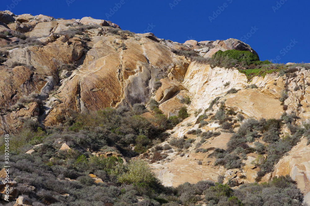 Coastal rock landscape in California on a bright sunny day with deep blue sky	