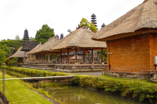 The beautiful buildings of the royal family temple in Bali separated by a river of water. Indonesia