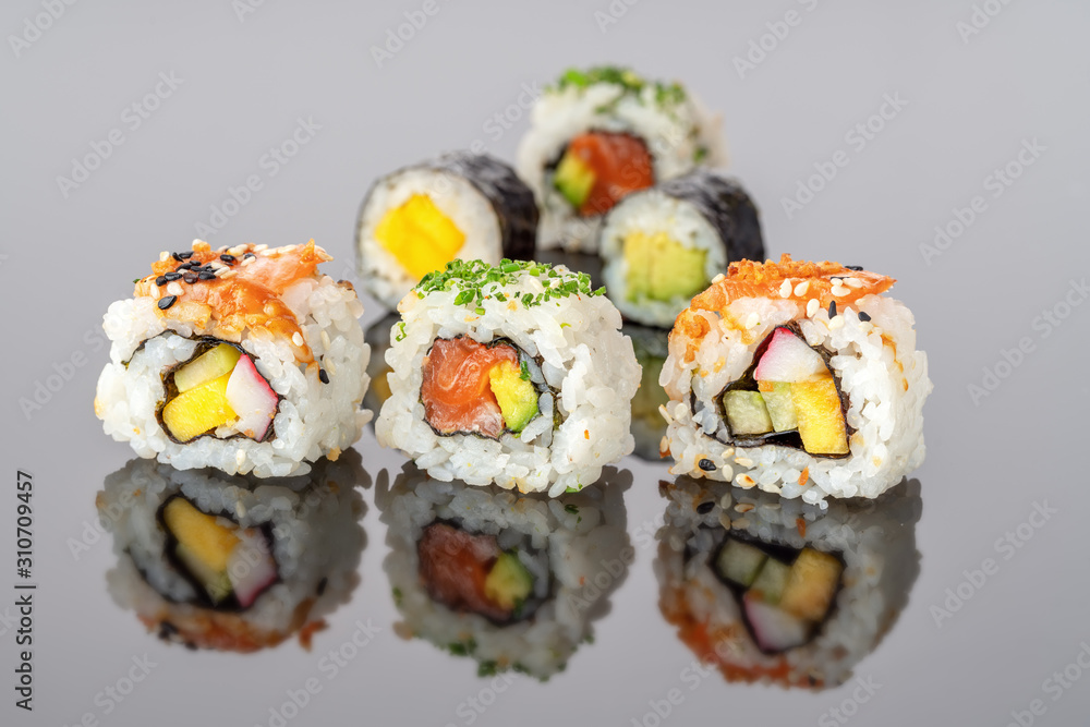 Japanese food sushi rolls uramaki in reflection close-up. Japanese food sushi rolls uramaki in reflection close-up.