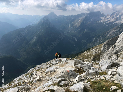 Hikers under Prisojnik peak in Julian Alps, Slovenia