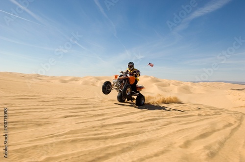 Quad Bike Rider Doing Wheelie In Desert © moodboard