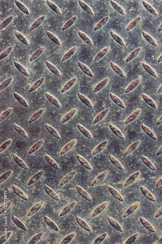 Texture of a rusty steel checkered plate with small rice projections