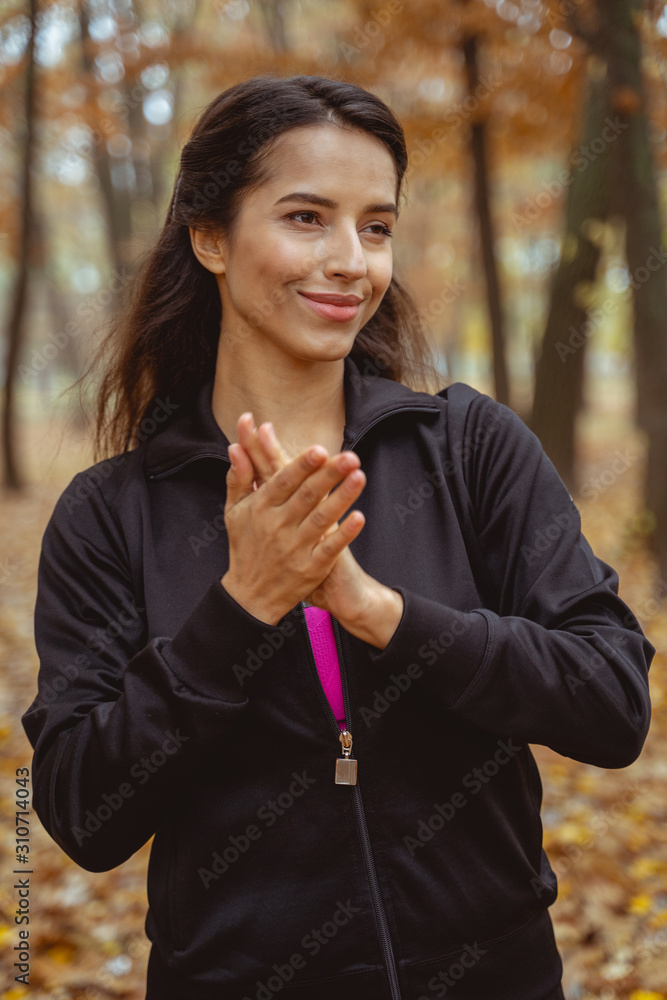 Portrait of pleased female that holding hands together Portrait of pleased female that holding hands together