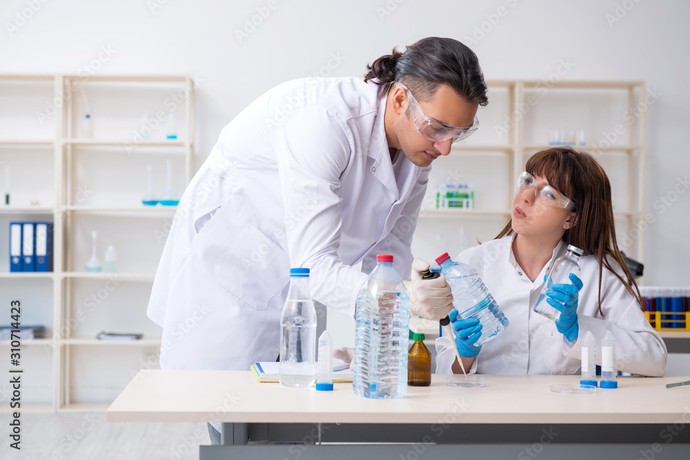 Two chemists working in the lab Two chemists working in the lab